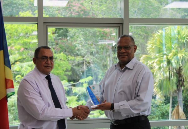 CEO Vel accepting the token of appreciation from Minister Derjacques